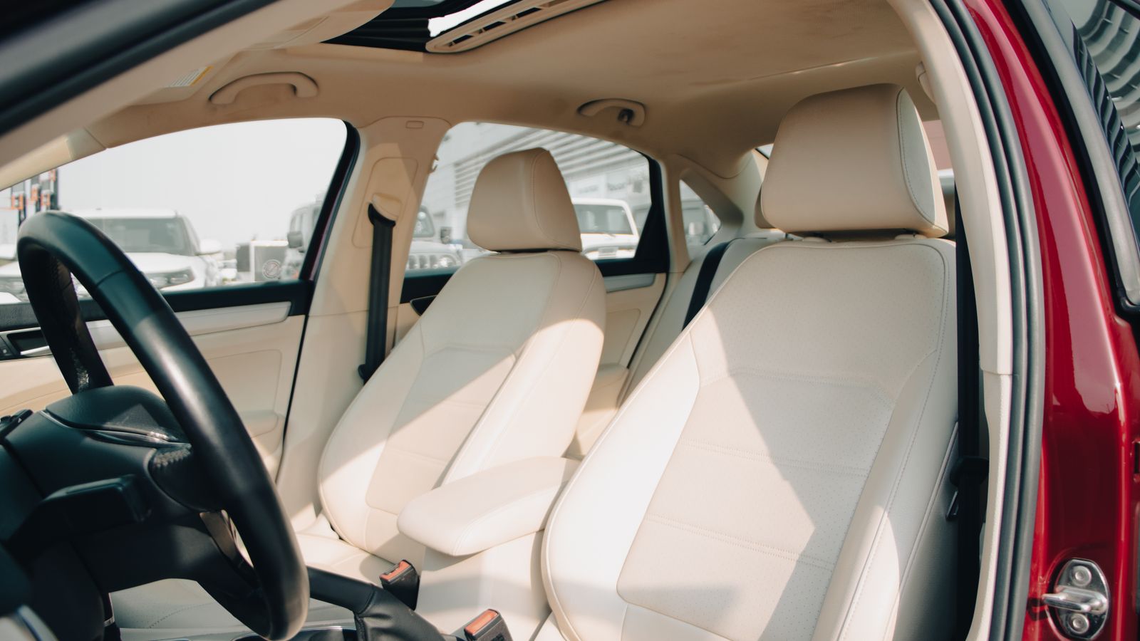 Spacious car interior featuring elegant cream leather seats and modern design elements.